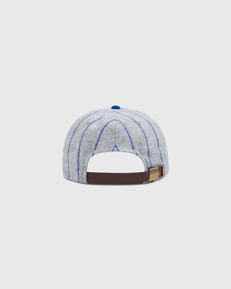 The Brooklyn Royal Giants Authentic Wool Ballcap by Ebbets Field features a light gray wool fabric with thin blue vertical stripes, showcased here from the back to display its brown adjustable strap and blue top button—a classic design inspired by caps worn by legendary teams in Black baseball history.