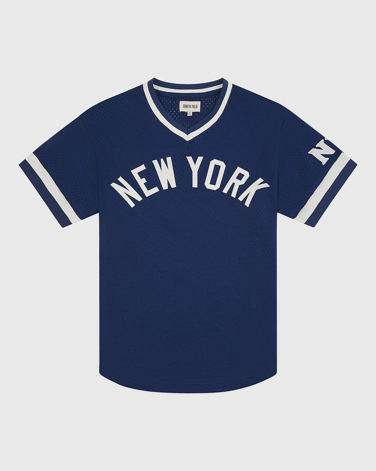 The Ebbets Field NY Black Yankees V-Neck Mesh Jersey is a blue short-sleeve jersey featuring white “NEW YORK” lettering on the chest and an “NY” logo on the left sleeve, with white trim on the collar and sleeves—an authentic design inspired by classic Negro National League NY Black Yankees uniforms.