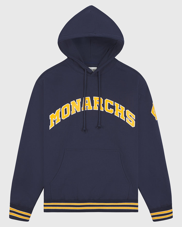 The Kansas City Monarchs 1924 Road Jersey Pullover Hoodie by Ebbets Field features “MONARCHS” in yellow on navy, a yellow patch on the left sleeve, front pocket, and striped rib cuffs and hem.