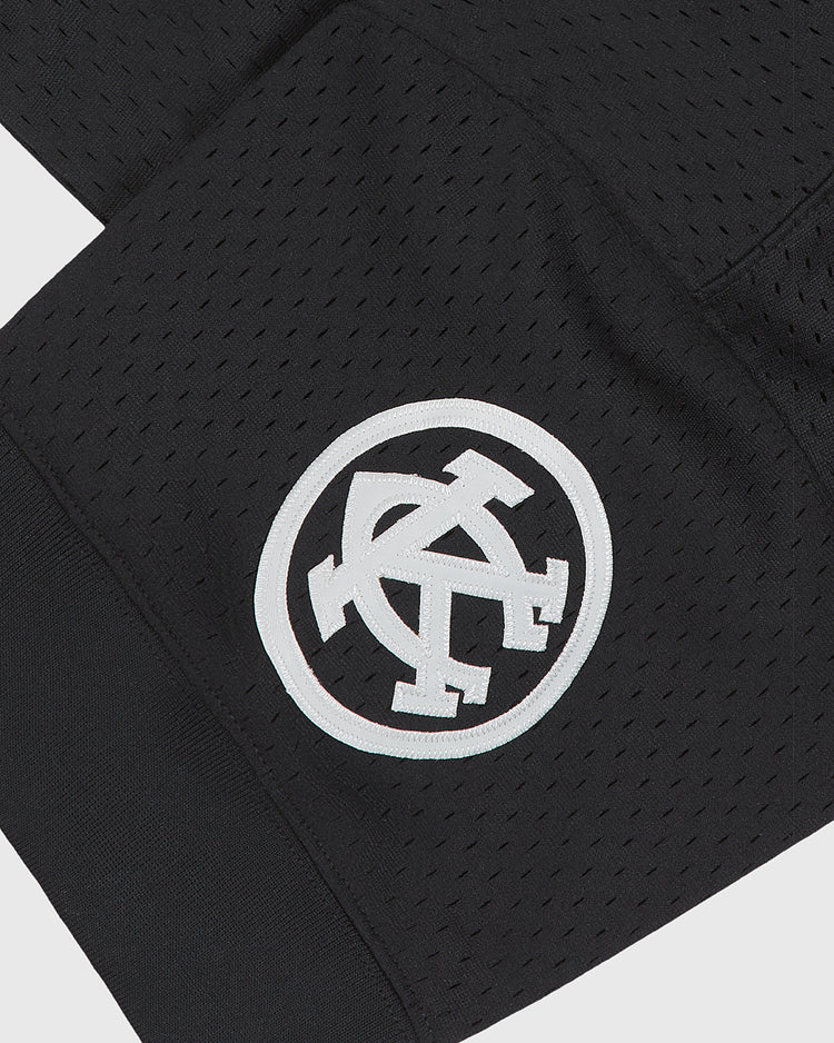 Black mesh Kansas City Monarchs 1924 Road Jersey V-Neck Mesh sleeve with a white circular patch featuring a stylized KC monogram.