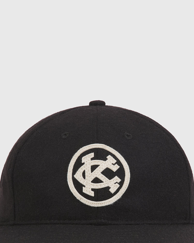 Black Kansas City Monarchs 1924 Authentic Wool Ballcap featuring a white circular patch with the letters KC intertwined.