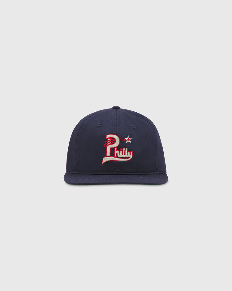 The Ebbets Field Philadelphia Stars Cotton Twill Ballcap is a navy blue baseball cap made from cotton twill, featuring a red, white, and cream Philly logo with a star on the front, reminiscent of a classic Philadelphia Stars ballcap and shown against a plain white background.