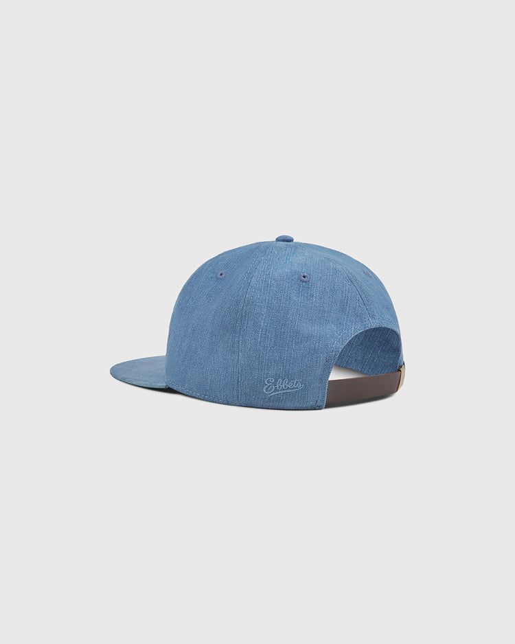 An indigo cotton denim ballcap from Ebbets Field is shown from the back, featuring a curved brim and an adjustable strap. The Ebbets Field name is subtly embroidered near the opening, evoking classic style. Set against a plain white background, this Los Angeles (PCL) cap pays homage to timeless designs worn throughout Pacific Coast League history.