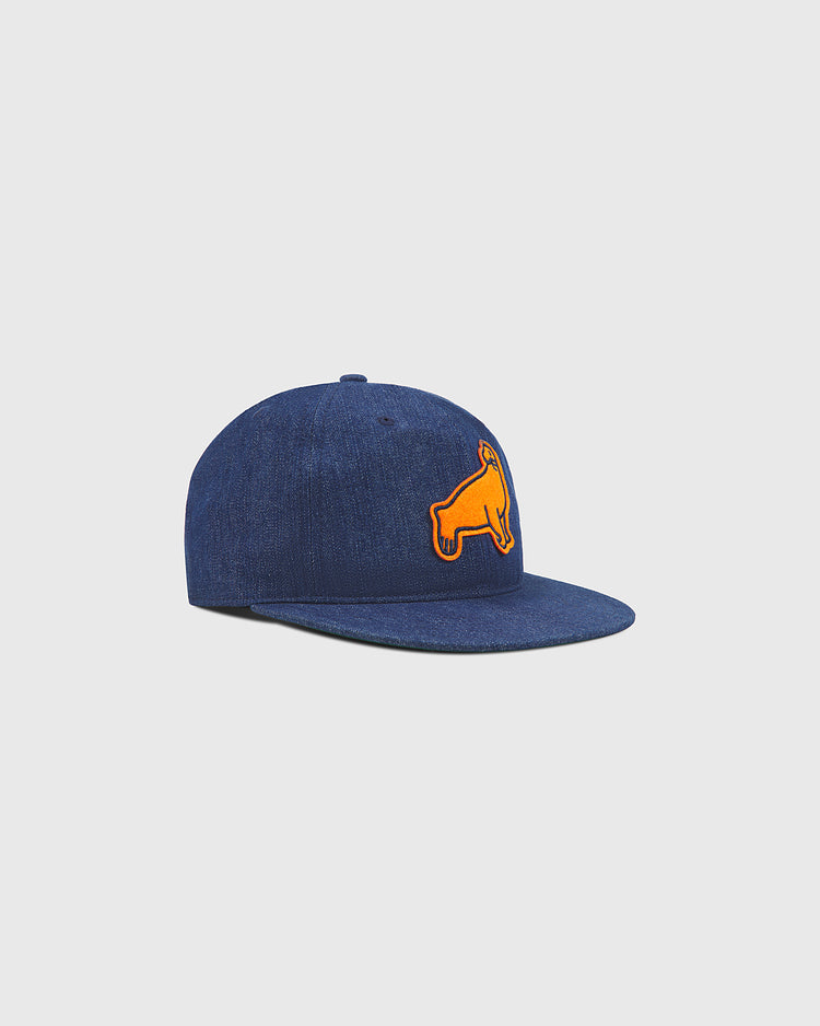 The Ebbets Field San Francisco Seals Indigo Cotton Denim Ballcap is a blue denim baseball hat styled after a classic 1940s cap, featuring an orange patch of a stylized animal on the front panel, flat brim, and shown against a light gray background.