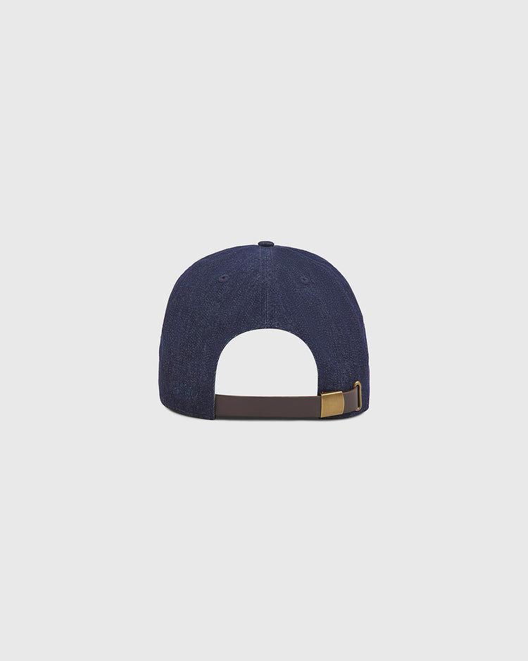The Ebbets Field Fuji Athletic Club Indigo Cotton Denim Ballcap is displayed from the back, showcasing a brown adjustable strap with a brass fastening buckle. Set against a plain light gray background, the refined simplicity of its Japanese Baseball-inspired design stands out.