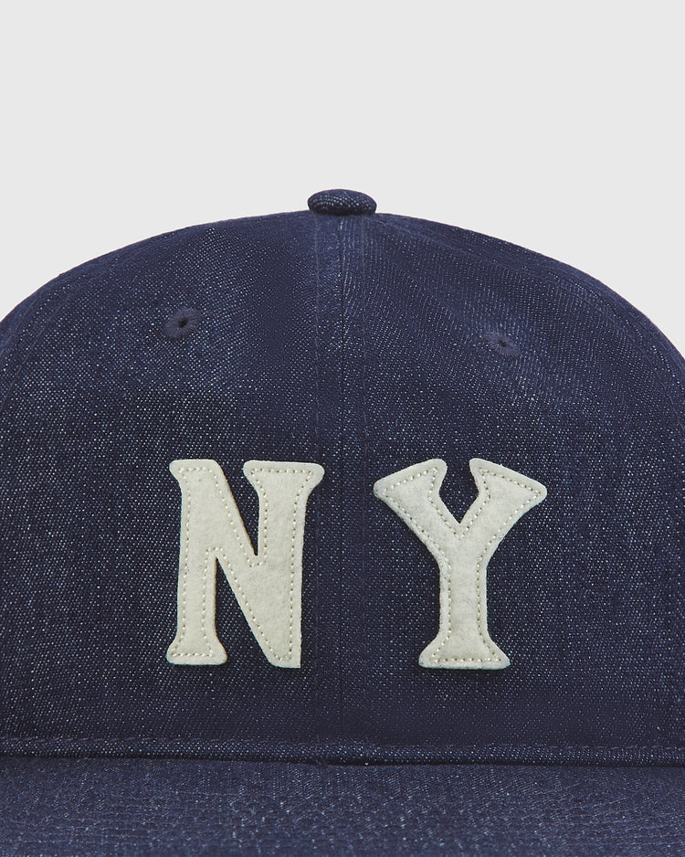A close-up of the Ebbets Field New York Black Yankees Indigo Cotton Denim Ballcap featuring large, white, stitched 