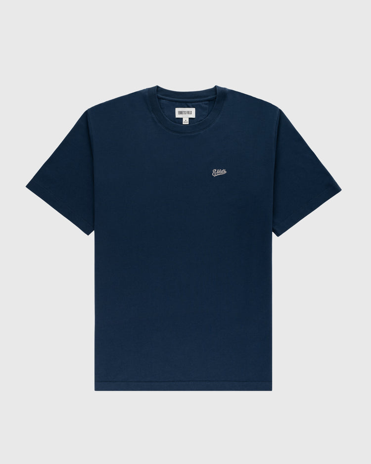 The Ebbets Field Flannels Ebbets Chest Logo Short Sleeve Tee is a durable navy cotton shirt featuring a small white embroidered logo on the left chest, shown against a light gray background.