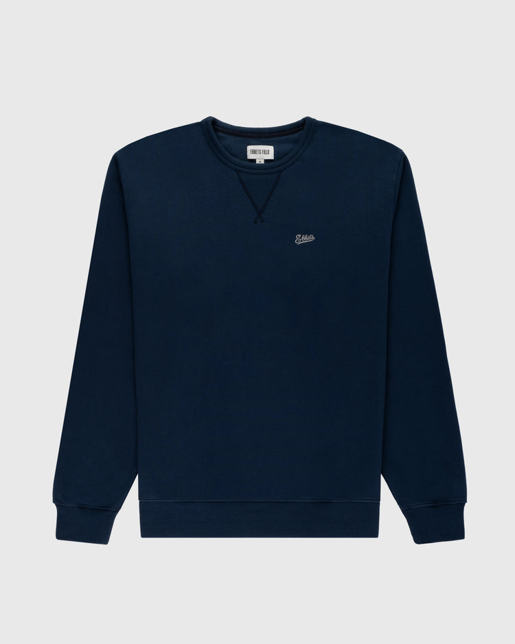The Ebbets Chest Logo Heavyweight Cotton Terry Crewneck by Ebbets Field Flannels is a navy blue long-sleeve sweatshirt with ribbed cuffs and hem, plus a small embroidered logo on the left chest, shown on a light gray background.