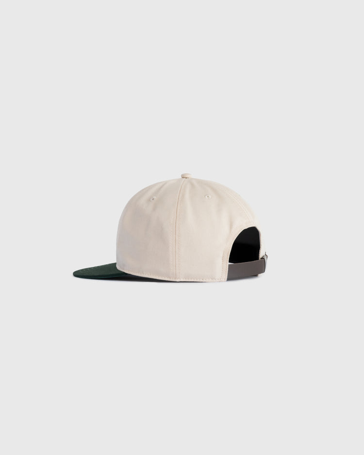 The Ebbets Field Flannels Ebbets Felt Script Cotton Twill Ballcap, shown from the back in beige with a dark green brim, features an adjustable strap and metal clasp—ideal for everyday wear—on a light gray background.