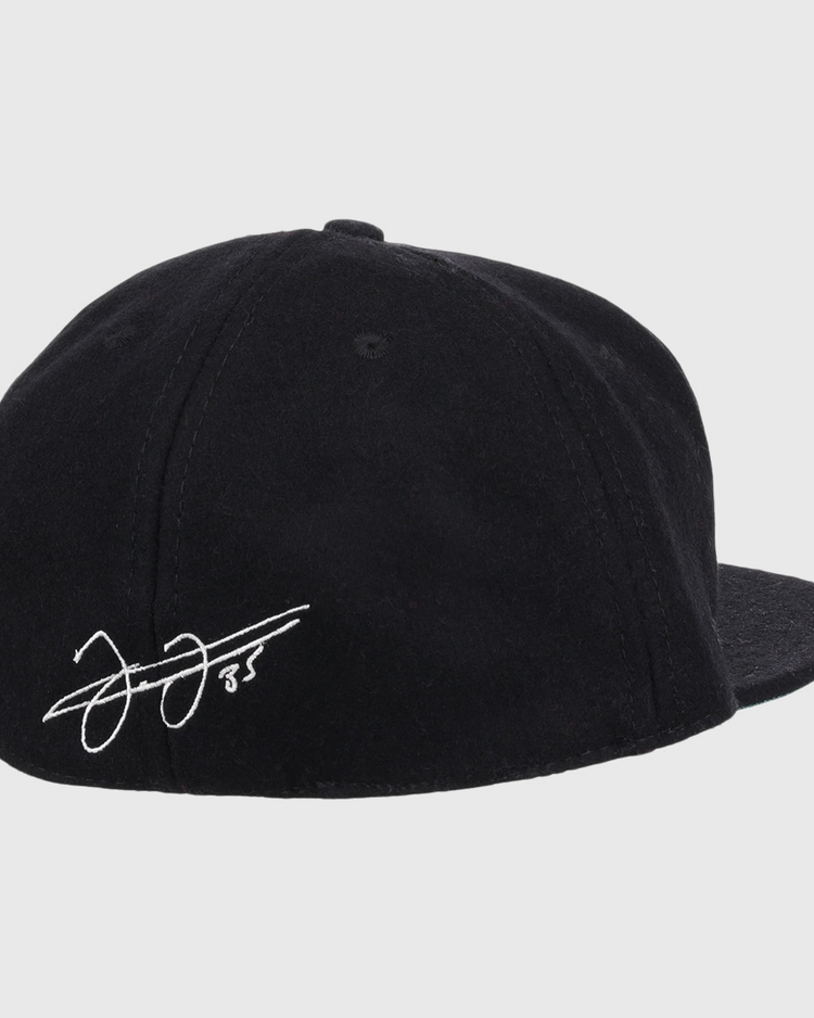 The Frank Thomas Signature Series Ballcap by Ebbets Field Flannels is a black vintage wool cap, seen from the back, with a white Frank Thomas signature and the number 85 on the left side above the brim.