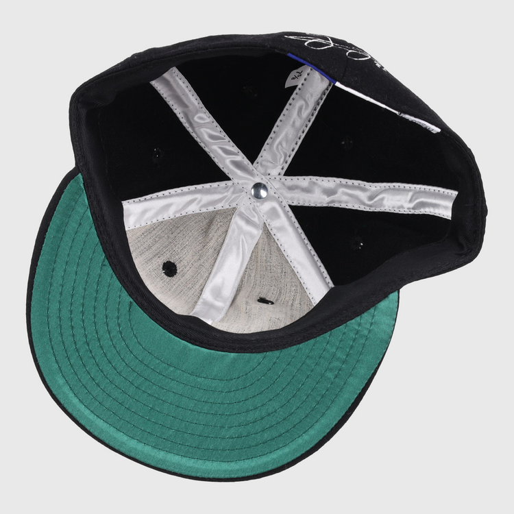 Inside view of the Ebbets Field Flannels Frank Thomas Signature Series Ballcap - Black features a green brim, white lining, black ventilation holes, and a silver crown button.