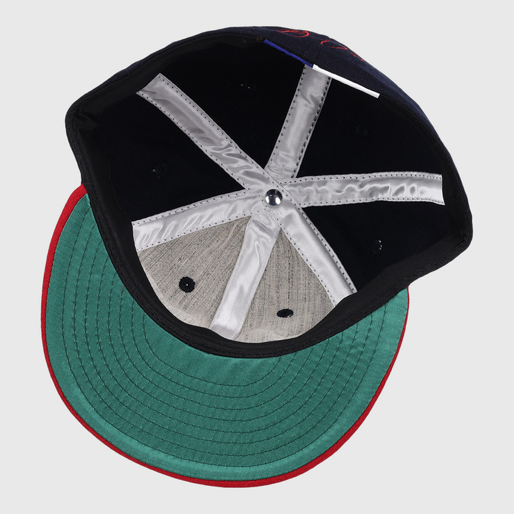 Inside view of the Ebbets Field Flannels Frank Thomas Signature Series Ballcap - Navy, featuring a green underbrim, red edge trim, black interior, white satin taping, and a metallic crown button—a Chicago White Sox classic.