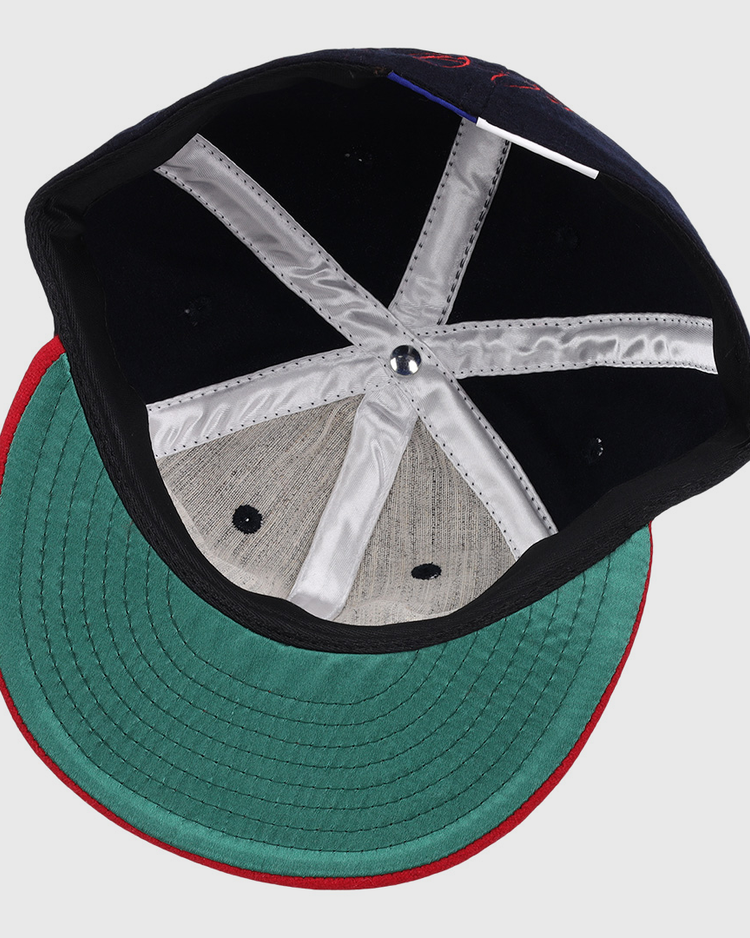 Inside view of the Ebbets Field Flannels Frank Thomas Signature Series Ballcap - Navy, featuring a green underbrim, red edge trim, black interior, white satin taping, and a metallic crown button—a Chicago White Sox classic.