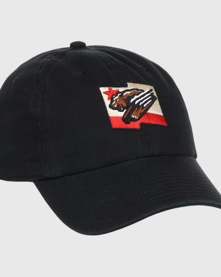 The Fresno Grizzlies MiLB Dad Ballcap by Ebbets Field is a black cap featuring a patch with a stylized bear, red star, and red stripe, inspired by the California state flag design.