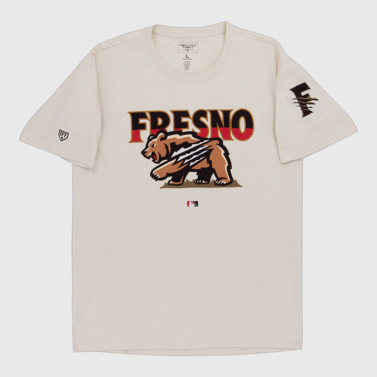 The Ebbets Field Fresno Grizzlies MiLB Fashion Cotton Short Sleeve Tee is a beige shirt with a bear graphic and claw marks, 