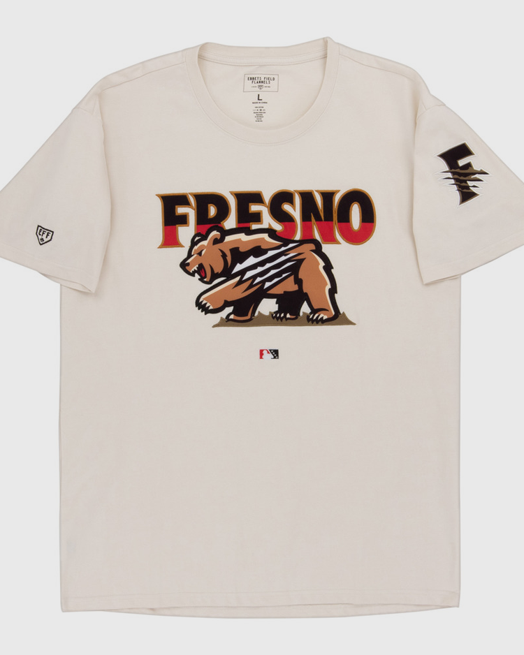 The Ebbets Field Fresno Grizzlies MiLB Fashion Cotton Short Sleeve Tee is a beige shirt with a bear graphic and claw marks, 