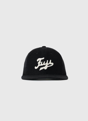 The Fuji Athletic Club 1931 Authentic Wool Ballcap by EFF features black genuine wool and a white cursive Fuy logo on the front, paying homage to Japanese-American baseball history. Displayed on a plain light gray background.