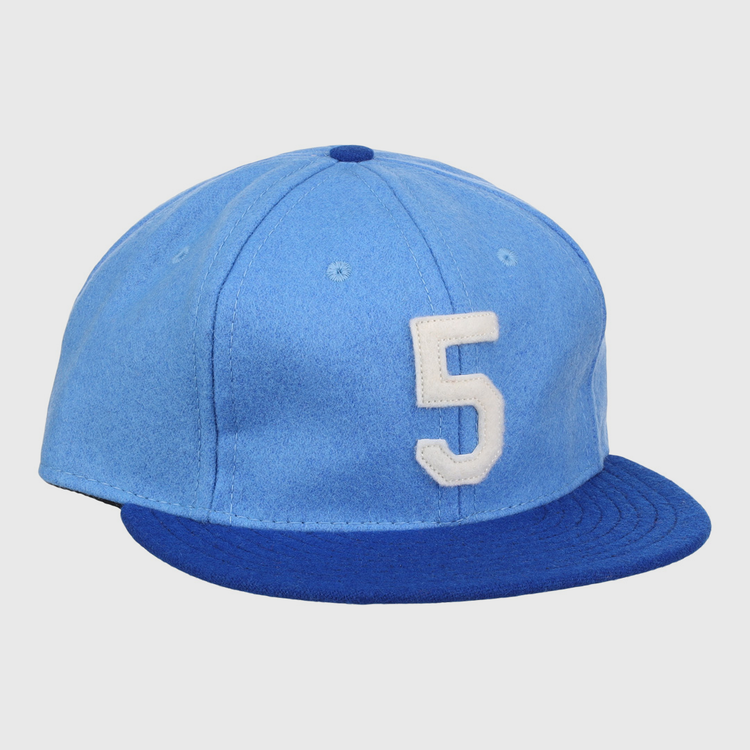 The Ebbets Field Flannels George Brett Signature Series Ballcap features vintage light blue wool, a dark blue brim, and a white number 5 on the front, inspired by classic styles from the National Baseball Hall of Fame.