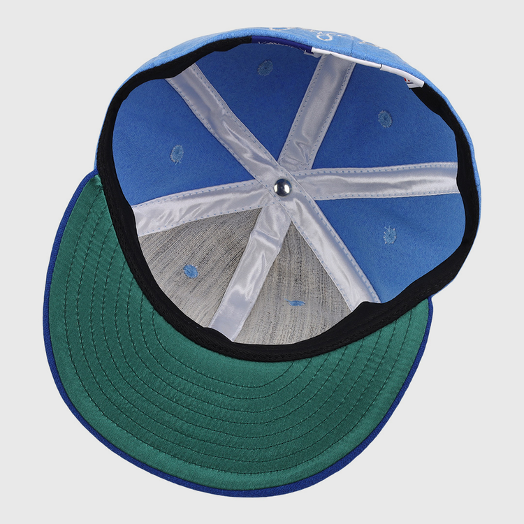 The interior of the George Brett Signature Series Ballcap by Ebbets Field Flannels features white seams, a green underbrim, and a small metal button at the top center.