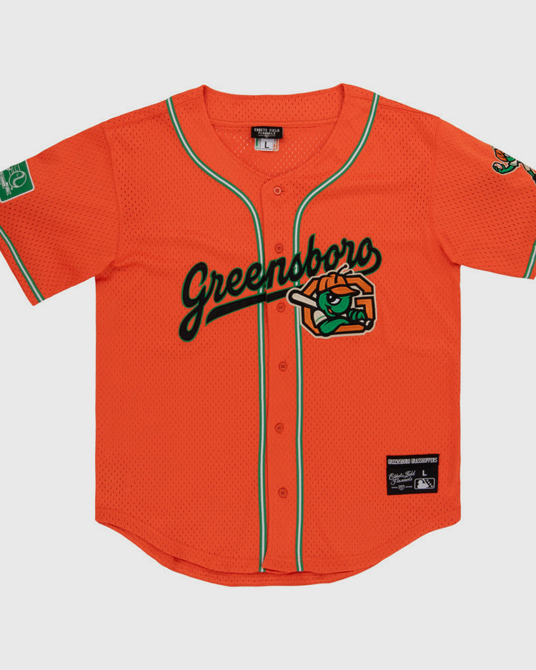 The Ebbets Field Greensboro Grasshoppers MiLB Button Down Jersey features bright orange fabric with green trim, 