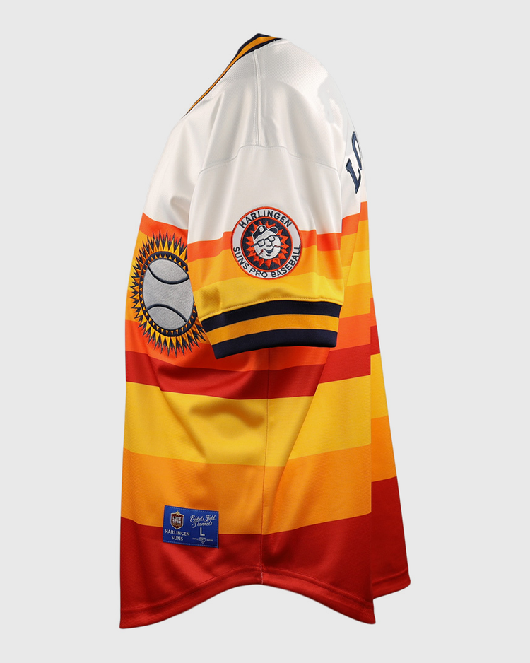 The EFF Harlingen Suns EFF Lone Star Baseball Jersey features bold yellow, orange, and red stripes with white shoulders and sleeves, plus sleeve patches of a baseball and the Harlingen Suns team logo from the Lone Star League.
