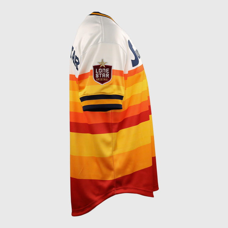 The Harlingen Suns EFF Lone Star Baseball Jersey by EFF features red, orange, yellow, and white horizontal stripes and a Lone Star patch on the sleeve, inspired by Texas baseball and the Harlingen Suns of the Lone Star League. Shown in side view.
