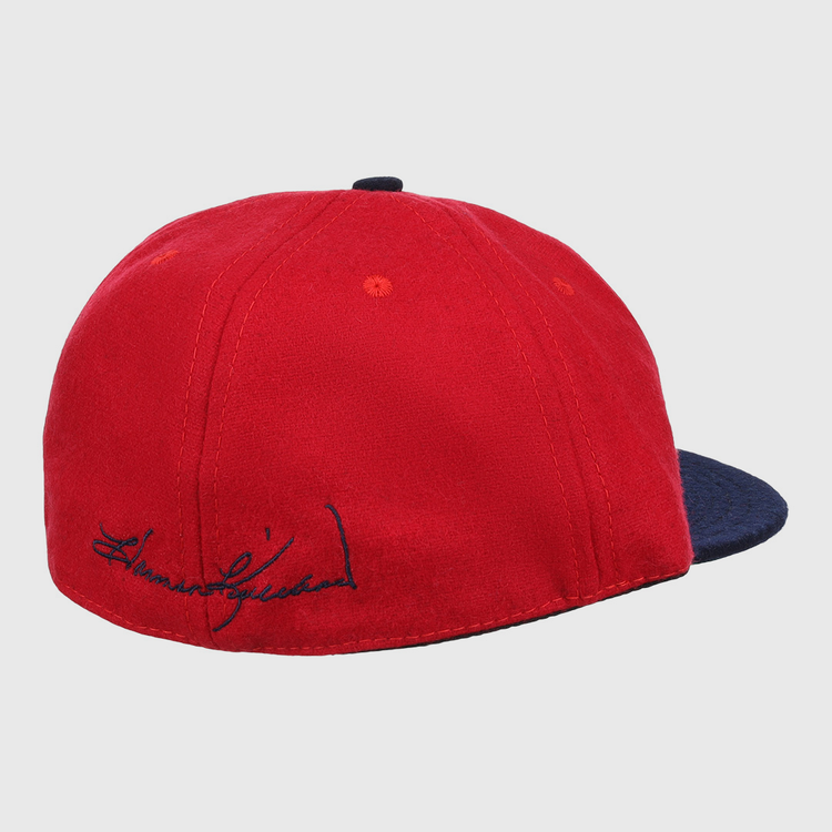 The Ebbets Field Flannels Harmon Killebrew Signature Series Ballcap features red vintage wool, a dark blue brim, and a black embroidered signature above the brim—perfect for National Baseball Hall of Fame fans. Plain white background.
