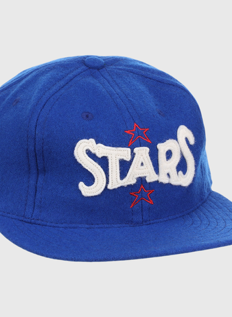 The EFF Hollywood Stars Letterhead Wool Vintage Ballcap is a blue wool hat featuring STARS in large white letters and two red stars, inspired by the classic Pacific Coast League Hollywood Stars cap.