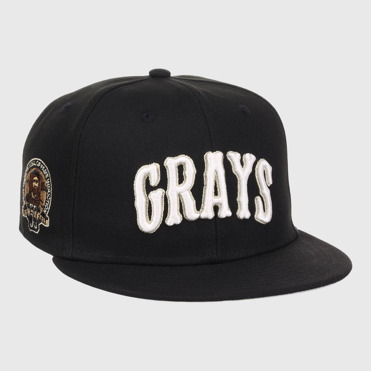 The EFF Homestead Grays Josh Gibson Fitted Ballcap in black features bold white GRAYS lettering on the front and a small embroidered portrait patch with text on the left side.