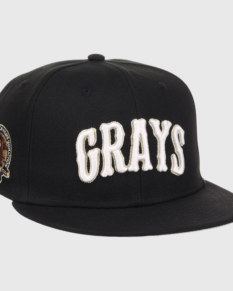 The EFF Homestead Grays Josh Gibson Fitted Ballcap in black features bold white GRAYS lettering on the front and a small embroidered portrait patch with text on the left side.