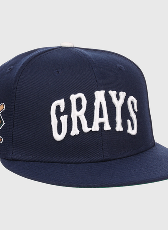 The EFF Homestead Grays NLB Flip Fitted Ballcap is a navy blue cap with GRAYS in bold white letters and a crossed bats “G” emblem, honoring the legendary Pittsburgh Homestead Grays.