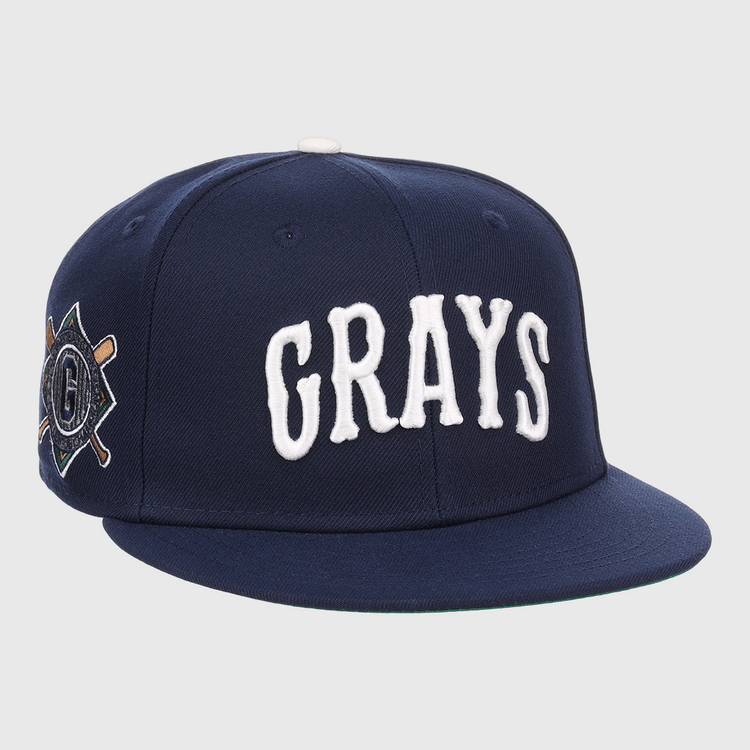 The EFF Homestead Grays NLB Flip Fitted Ballcap is a navy blue cap with GRAYS in bold white letters and a crossed bats “G” emblem, honoring the legendary Pittsburgh Homestead Grays.