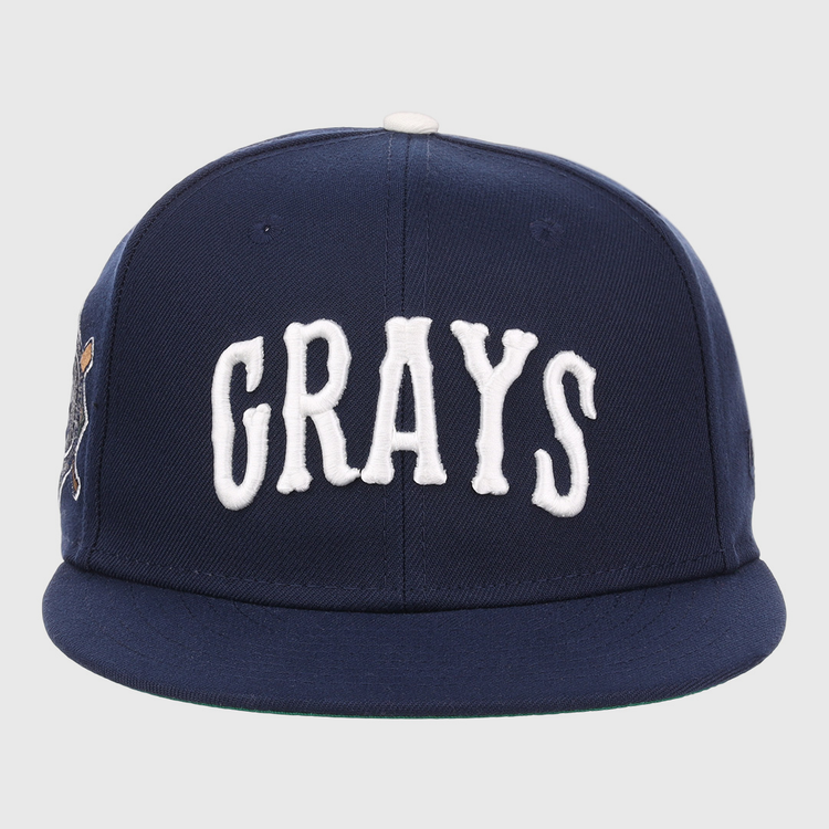 The EFF Homestead Grays NLB Flip Fitted Ballcap is a navy blue cap featuring GRAYS in bold white letters, honoring the legendary Pittsburgh baseball team.