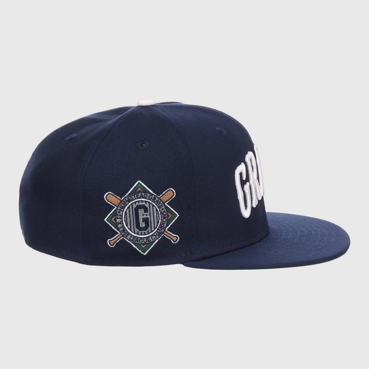 The EFF Homestead Grays NLB Flip Fitted Ballcap features a navy flat-brim, bold white GRD letters up front, and a diamond patch with bats and G logo on the side, honoring Pittsburgh’s legendary Homestead Grays.