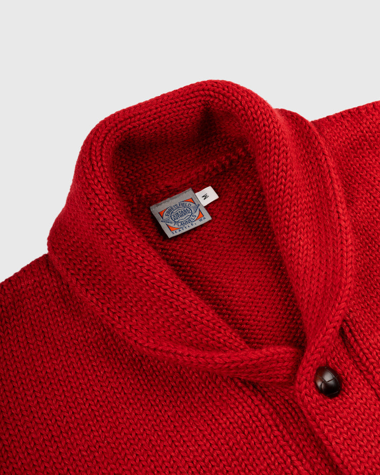 Close-up of the EFF Harvard University 1940 Wool Shawl Collar Sweater, a bright red vintage cardigan with visible brand label and dark button on a light background, inspired by the classic 1940 replica.