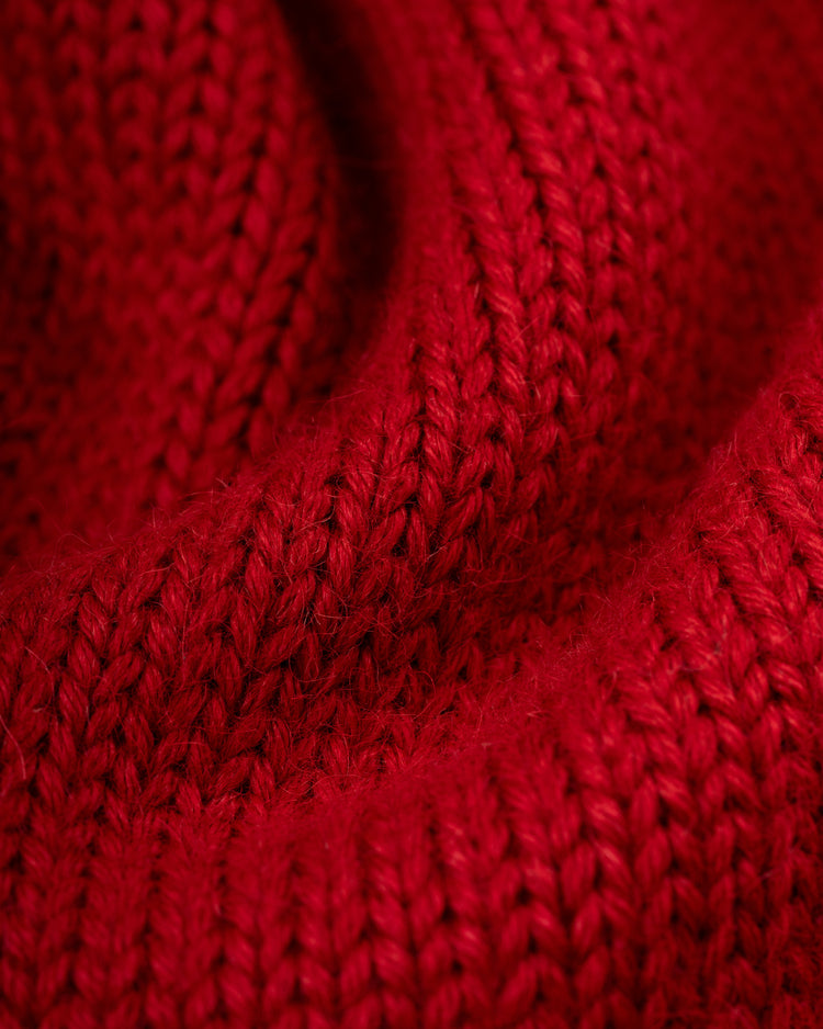 Close-up of the EFF Harvard University 1940 Wool Shawl Collar Sweater’s red knit, highlighting its thick yarn, textured stitches, and soft folds inspired by the original 1940 design.