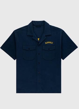The Ebbets Field Hawaii Islanders (PCL) Cotton Linen Grounds Crew Short Sleeve Workshirt in navy features two chest pockets and HAWAII embroidered in yellow above the left pocket, shown on a plain light gray background.