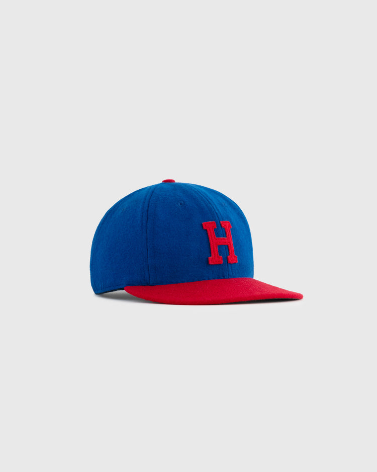 The EFF Hollywood Stars 1949 Authentic Wool Ballcap features a blue crown, red brim, and red letter H on the front, shown against a light gray background.