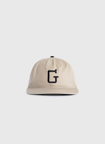 The Ebbets Field Flannels Homestead Grays Embroidered G Cotton Twill Ballcap, shown on a plain white background, features beige cotton twill and a black embroidered letter G in tribute to baseball history.