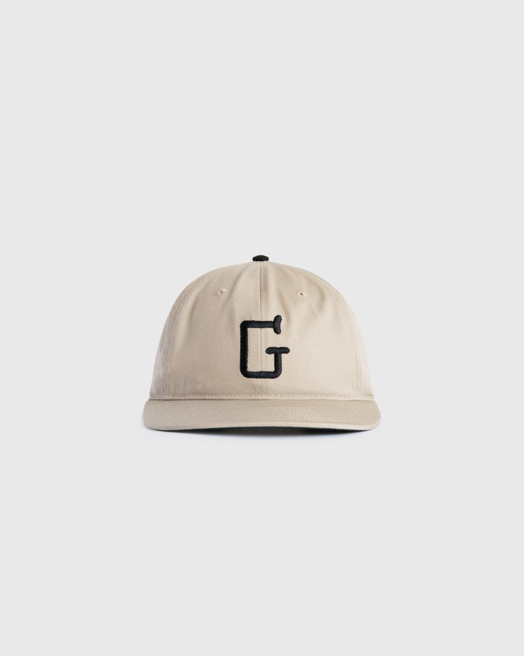 The Ebbets Field Flannels Homestead Grays Embroidered G Cotton Twill Ballcap, shown on a plain white background, features beige cotton twill and a black embroidered letter G in tribute to baseball history.