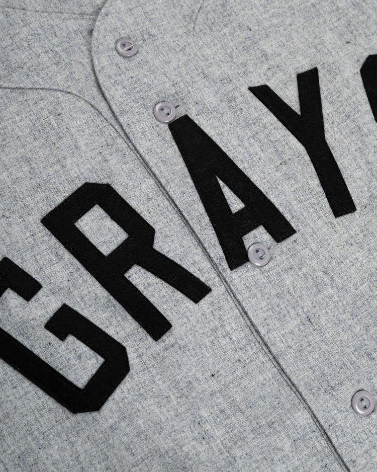 Close-up of the Ebbets Field Flannels Homestead Grays 1944 Authentic Wool Road Baseball Jersey, featuring bold black GRAYS lettering—a timeless tribute to the Negro Leagues.