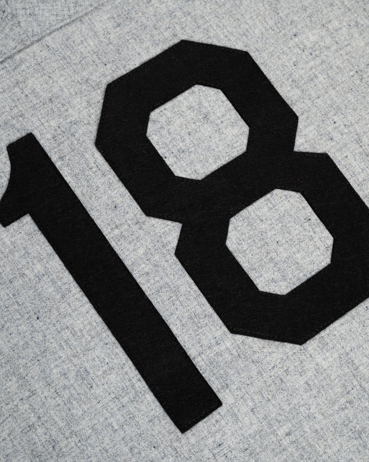 Large black “18” numbers stand out on the textured light gray wool of the Ebbets Field Flannels Homestead Grays 1944 Authentic Wool Road Baseball Jersey, capturing the look of a classic Homestead Grays jersey.