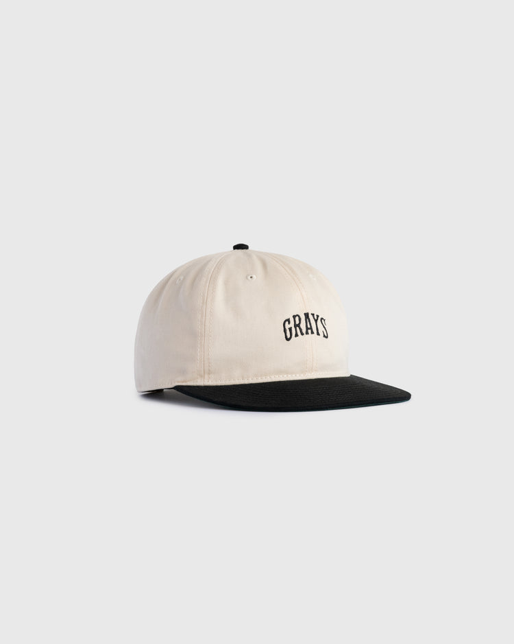 The Ebbets Field Flannels Homestead Grays Embroidered Two Tone Cotton Twill Ballcap features a beige crown, black brim, and GRAYS stitched in black on the front, paying tribute to classic Negro Leagues style.