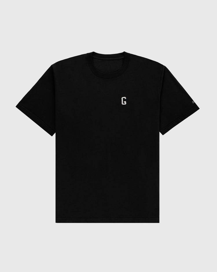 The Ebbets Field Flannels Homestead Grays Embroidered G Short Sleeve Tee features a small white G on the left chest, honoring Josh Gibson and the Homestead Grays, shown against a light gray background.