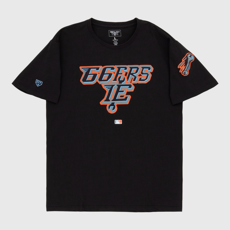 The Ebbets Field Inland Empire 66Ers MiLB Fashion Cotton Short Sleeve Tee features a black design with a blue, orange, and white stylized 66ERS IE logo on the chest, a flaming baseball graphic on the sleeve, and an official MLB logo near the hem.