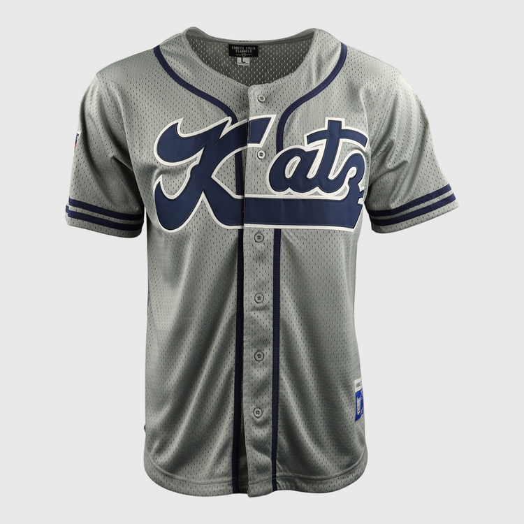 The EFF Kansas City Katz DNA Replica Button-Up Mesh Jersey features gray fabric with navy accents, Katz in large script on the front—a tribute to Katz Drugstore and the Ban Johnson Baseball League. It has front buttons and short sleeves.