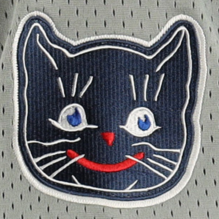 The Kansas City Katz EFF DNA Replica Button-Up Mesh Jersey by EFF features a smiling cat face with blue eyes, red nose and mouth on a gray perforated background, inspired by the iconic Katz Drugstore mascot. The cats face is outlined in white thread.