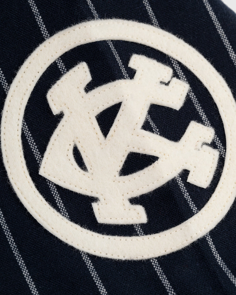 The Kansas City Monarchs 1924 Authentic Wool Road Baseball Jersey by Ebbets Field features classic pinstripes and vintage stitching, capturing the look of an authentic golden-era baseball jersey.