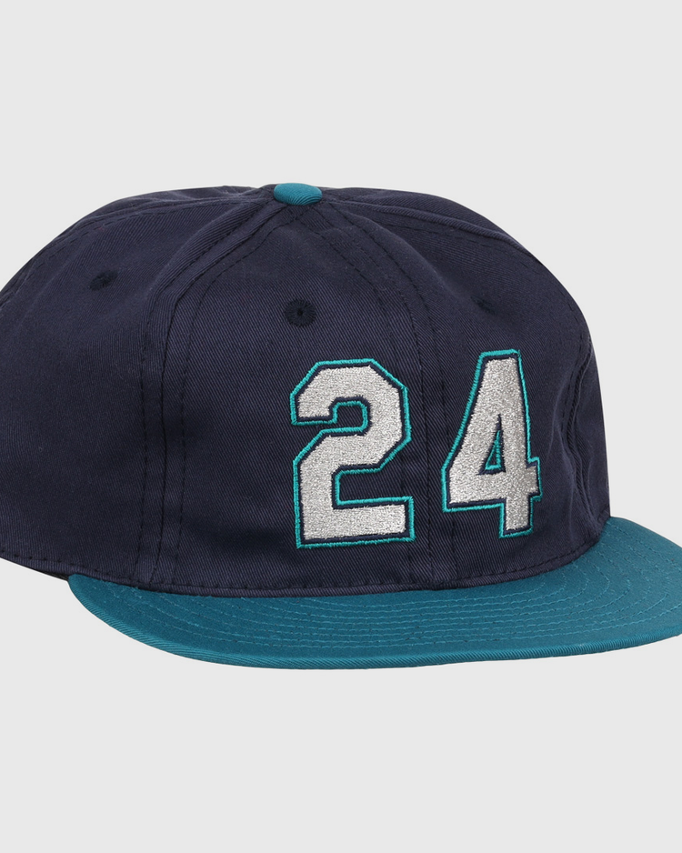 The Ebbets Field Flannels Ken Griffey Jr. 1995 Signature Series Ballcap is navy blue with a teal brim and button, and features the number 24 stitched in white and teal on the front.