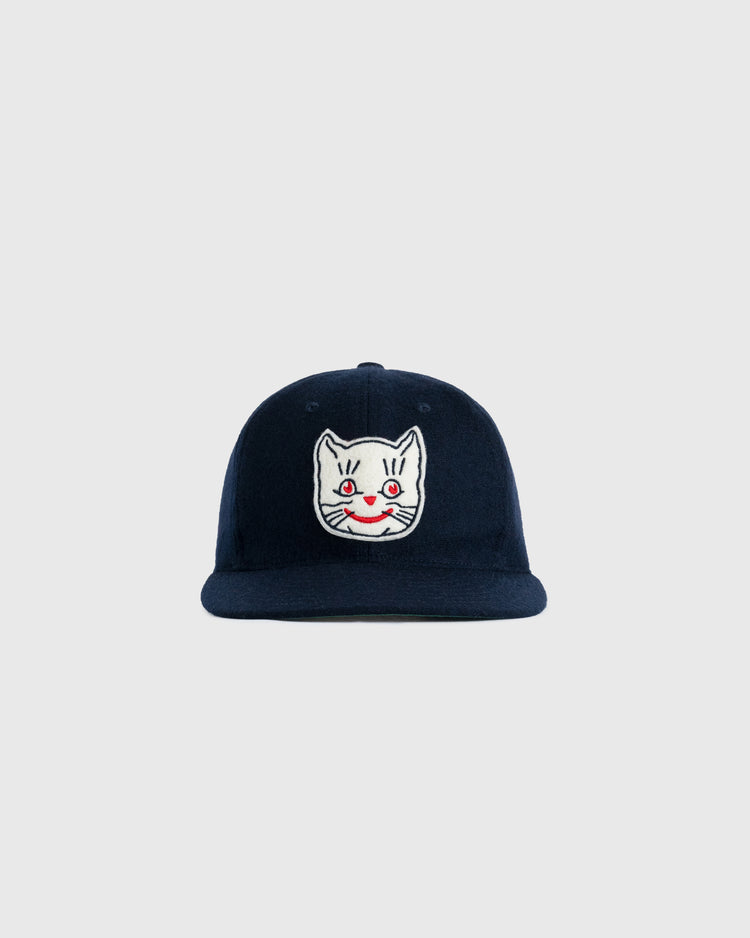 The EFF Kansas City Katz 1961 Authentic Wool Ballcap in navy features an embroidered white cat face with red eyes and a red smile on the front, shown against a plain light gray background.